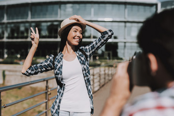 Canvas Print - Young man Taking Photo of Smiling Beautiful Woman