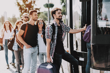 group of young people boarding on travel bus