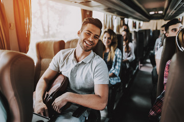 Wall Mural - Young Handsome Man Relaxing in Seat of Tour Bus