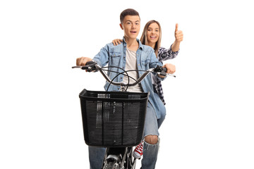 Poster - Smiling boy and girl riding on the same bike and giving thumbs up