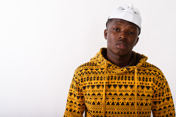 Wall Mural - Studio shot of young black African man wearing white mask on top