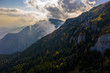 © Epic Vision - Aerial photography over big mountain forest. Sunset over the forest. Foggy valley at the sunrise. Golden hour over the forest with mist. Beautiful aerial landscape. Drone shots over the foggy forest.