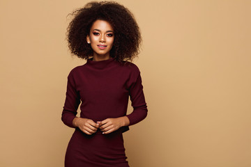 Black woman with afro hairstyle posing in studio with copy space