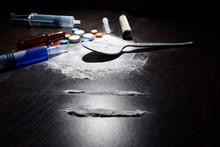 drugs concept , cocaine,injection,table,spoon on dark table.