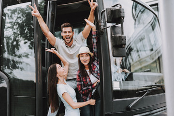 young smiling people traveling on tourist bus