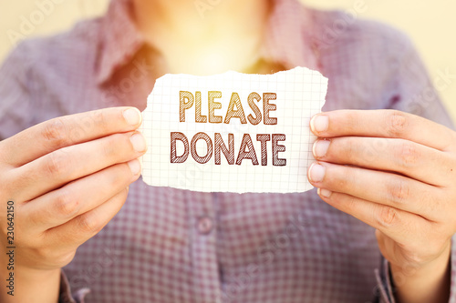 Cuadros en Lienzo business woman holding tear paper with please donate text
