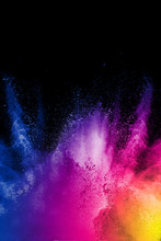 Color Powder Explosion Cloud On Black Background. Freeze Motion Of Color Dust  Particles Splashing.