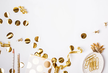 Wall Mural - Golden color decor and confetti on the white background