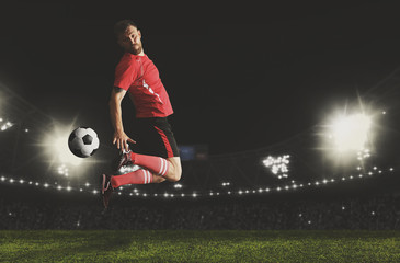 Wall Mural - Football player in action on a dark arena