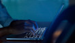 Close up businessman hand typing or working on laptop for programming about cyber security , advance future technology concept