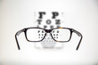 © erphotographer - Eyeglasses during optometric examination / Exam view with optometric table and tortoise glasses