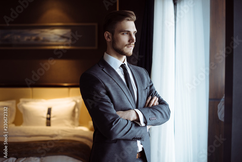 Cuadros en Lienzo Young handsome man relaxing at his apartment in a hotel after business meeting