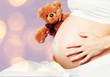 © BillionPhotos.com - Young pregnant woman with teddy bear on