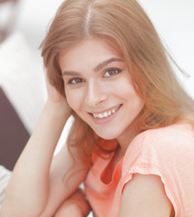 Wall Mural - portrait of young smiling woman in the background of the living room.