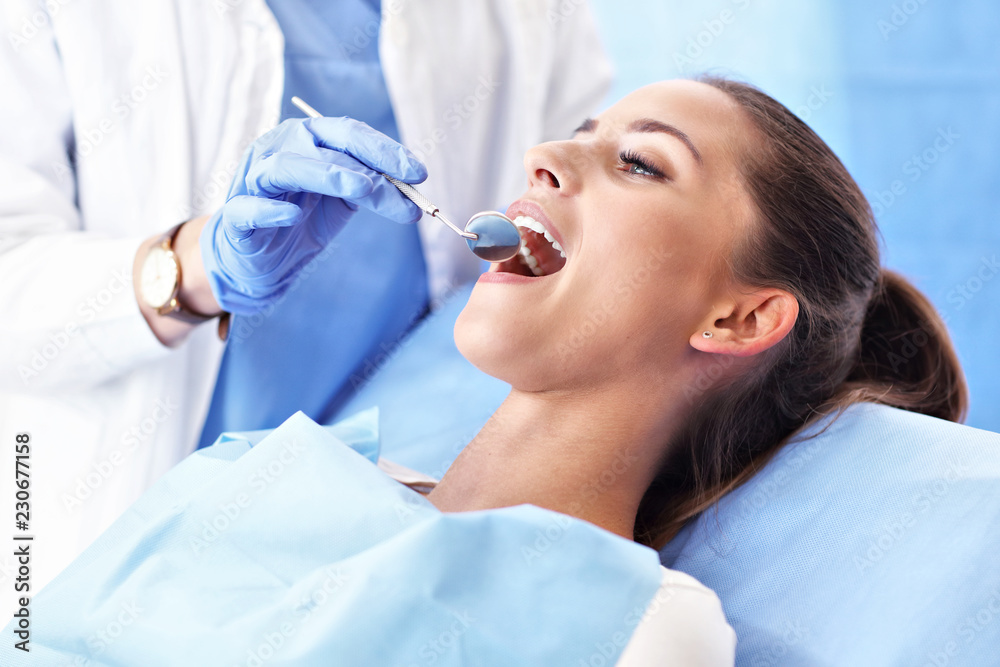 Adult woman having a visit at the dentist's - obrazy, fototapety, plakaty 