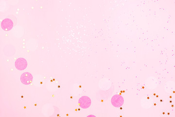 Wall Mural - Pink confetti and stars and sparkles on pink background.