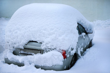 Wall Mural - Car covered with much snow.