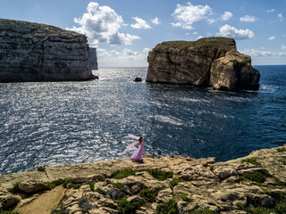 Sticker - Woman in wedding dress on the rugged Mediterranean Sea coast.  Island of Gozo, Malta