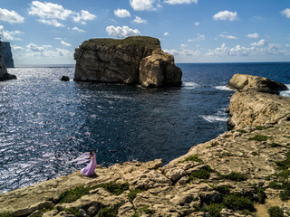 Sticker - Woman in wedding dress on the rugged Mediterranean Sea coast.  Island of Gozo, Malta