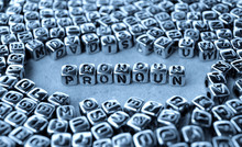 Pronoun - Word From Metal Blocks On Paper - Concept Photo On Table

