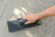 © aee_werawan - Hand on be bound with cement , do cement work, apply cement (over a surface)