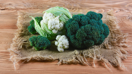 Wall Mural - Delicious broccoli and cauliflower has a wooden rustic table. Top view, place for text