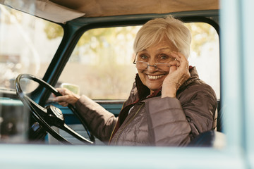 Wall Mural - Elder woman driving a old car