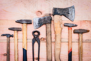 Set of vintage hand construction tools on a wooden background 