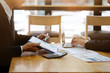 © Prathankarnpap - Businessman present with document paper on clipboard and consult with laptop.