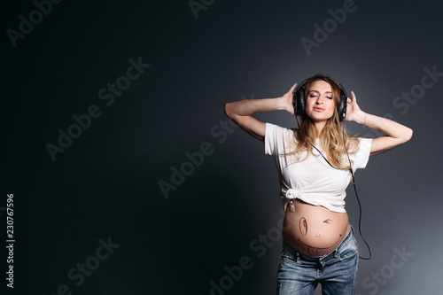 Portrait of beautiful pregnant woman with long hair dancing ...
