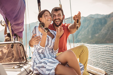 Wall Mural - Couple in love on a sail boat in the summer.