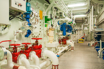 Wall Mural - Equipment, cables, pipes and valves in engine room of a ship power plant