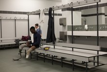 Two Disabled Athletes Relaxing In Changing Room