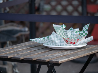 Paper plate with food truck and fast food wrappers and containers sitting on picnic table