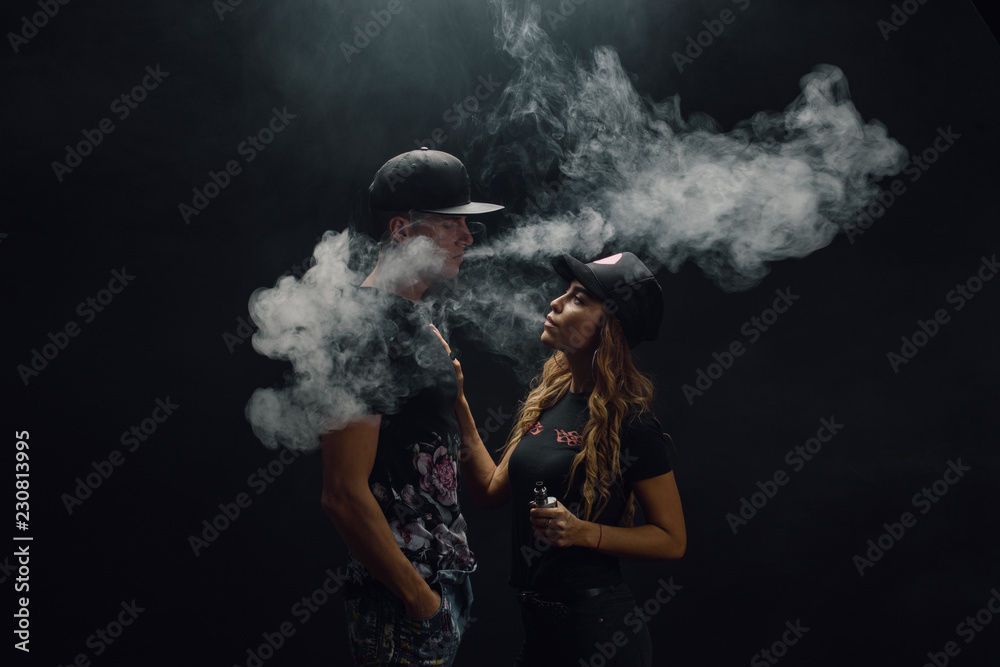 elf bar vape uk A girl is blowing smoke from a vape a portrait of a girl with red lips who  smokes