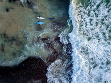 Aerial View Of Surfers Surfing In Sea