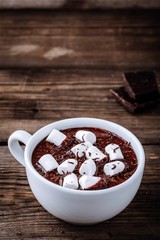 Wall Mural - A cup of hot chocolate or cocoa with marshmallows on wooden background