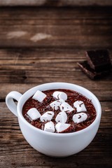 Canvas Print - A cup of hot chocolate or cocoa with marshmallows on wooden background