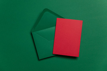 Wall Mural - Blank red card with green paper envelope Christmas card template mock up.