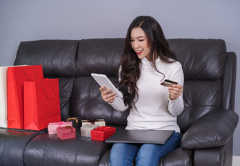 Sticker - woman shopping online for gift with laptop in living room