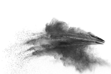 Black powder explosion on white background. Black dust particles splash.