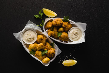 Wall Mural - Fried cauliflower in batter with a savory sauce of cashew nuts. healthy vegan fast food. Baked Buffalo Cauliflower 