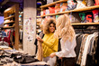 © BGStock72 - Two pretty young women choosing clothes from new collection in department store
