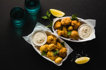 Wall Mural - Fried cauliflower in batter with a savory sauce of cashew nuts. healthy vegan fast food. Baked Buffalo Cauliflower 