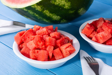 fresh watermelon cut into cubes on plates.