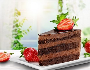 Sticker - Slice of delicious chocolate cake on desk