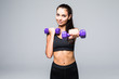 © F8  \ Suport Ukraine - Young attractive woman in sport clothes with beautiful smile holding weight dumbbell doing fitness workout isolated on white background. Healthy lifestyle concept