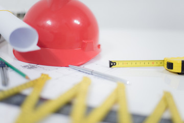 Architectural Office desk ,Desk table with construction tools, red helmet construction, pen, Pencil, Ruler and paper roll. Business concept.