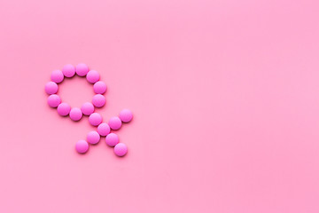 Wall Mural - Female diseases. Female gender icon symbol made of pills on pink background top view space for text