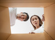 © Johnstocker - Happy couple opening a box and looking inside to product